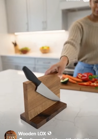 Handcrafted Wooden LOX magnetic knife holder made of walnut and oak wood with three black-handled kitchen knives attached.