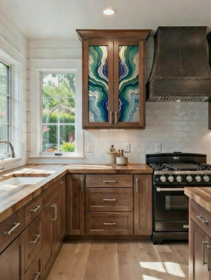 This image features a rustic-style kitchen highlighted by custom epoxy resin art panels integrated into the upper cabinet doors. 